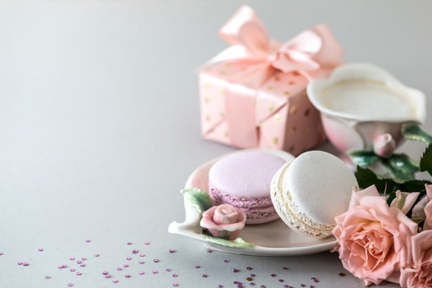 cup-coffee-pasta-cake-gift-box-pink-roses-gray-background-copy-space_127032-2186